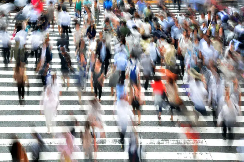 a crowd of people crossing a street